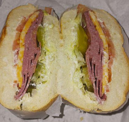 Beef salami with 3 pepper cheese and lettuce, tomatoes, and pickles.