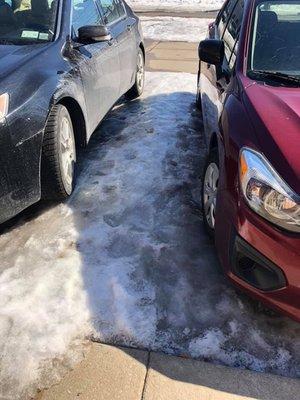 ice in between the cars in the parking lot