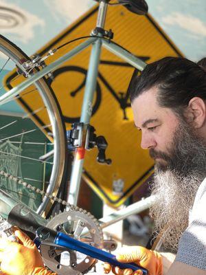 Bike mechanic finishing a service appointment