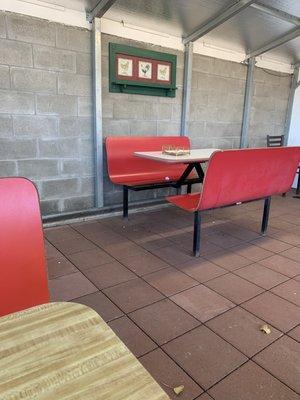 Covered seating area with about five tables