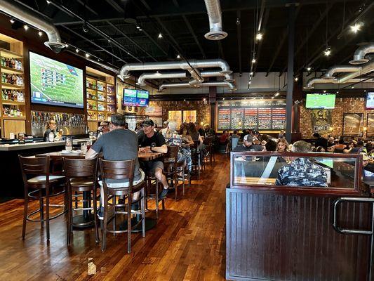 Bar area on left side with tables and booths you can dine at.