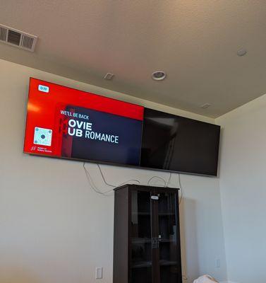 Two side by side wall mounted TVs installed