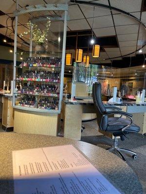 One of the few nail bars sections. Also plexiglass at the receptionist desk, and manicure/acrylic tables.