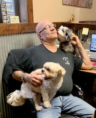 Violet and Daisy giving owner Ken kisses when they arrive.