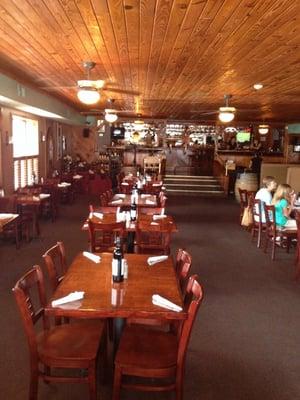 A view across the dining room to the bar at the far end.