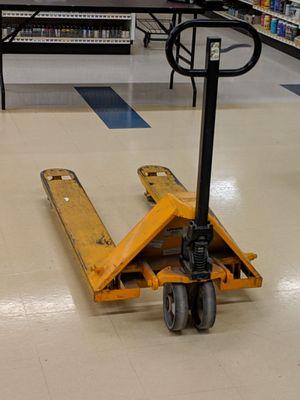 Pallet jack in an unsafe location and position posing a possible trip hazard!