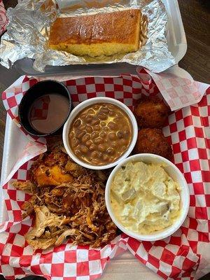 Brisket with sides of baked beans and potato salad