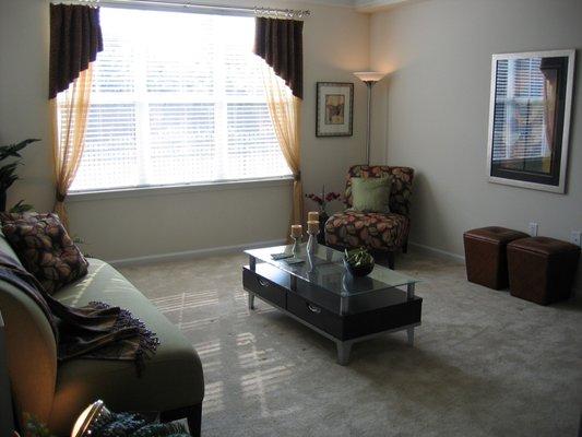 Living room with extra wide window at Gateway Park Apartments.