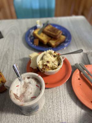 Hot chocolate, grits with bacon and cheese, French toast.