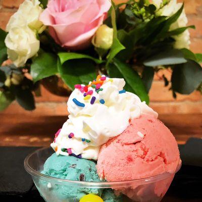 Double scoop mint flake and strawberry ice cream with toppings in upgraded dish.