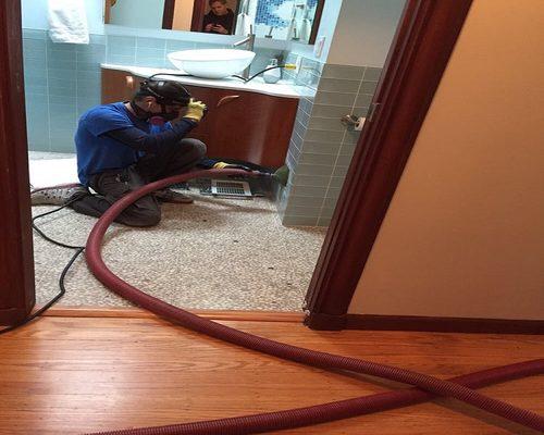 Cleaning the duct in the upstairs bathroom with the rotobrush vacuum system