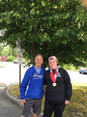 Lily Mitterhoff take silver and two bronze and New Jersey State Special Olympics.  Posing here with Ed Halper, Trainer at Mountain Fitness