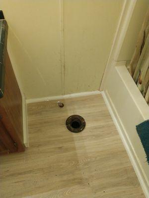 Replaced subfloor. Stabilized toilet flange and installed new laminate flooring.