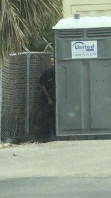 Employee urinating OUTSIDE of the port o potty.