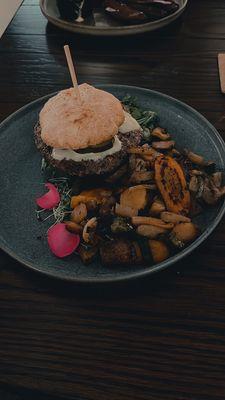 Emu burger on a gluten free bun with the seasonal vegetables