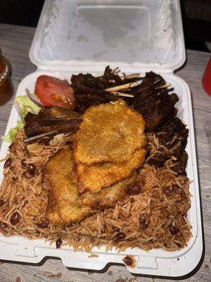 Fried turkey, rice and beans, fried green plantains, side of salad.