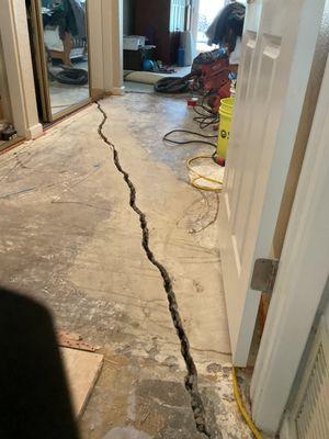 Large cement slab crack needing repair.