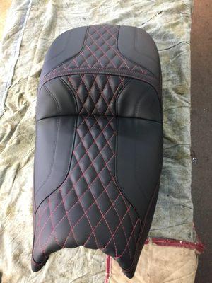 Motorcycle seat with diamond pattern in red stitching