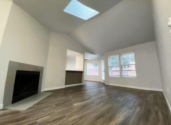 Our living space with Real Wood Fireplace, Skylight, Vaulted Ceilings, Hard wood floors & Spacious!