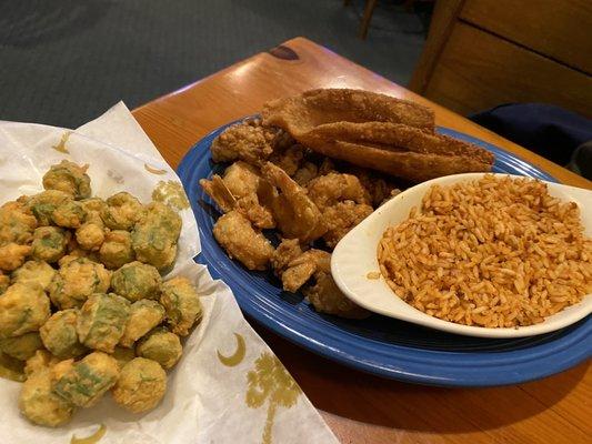 Trio platter (fried shrimp, oysters and flounder) comes with one side (rice) and coleslaw. We order an extra fried okra side to share