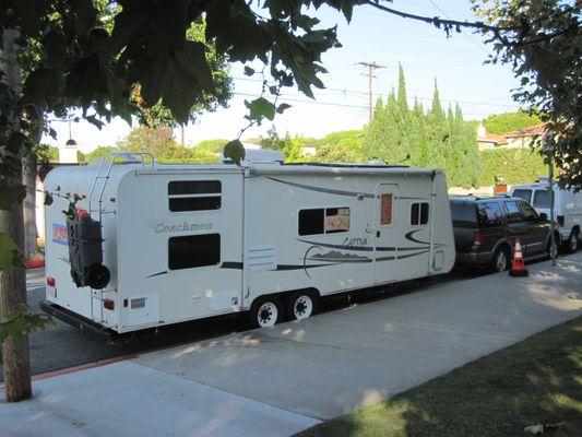 Trailer with homeless living inside next to Clover Park.