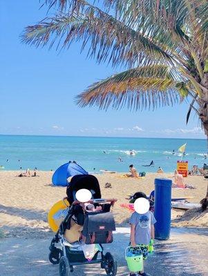 Getting ready to play in the sand - bring umbrellas to protect the kiddos (not a lot of shade!)