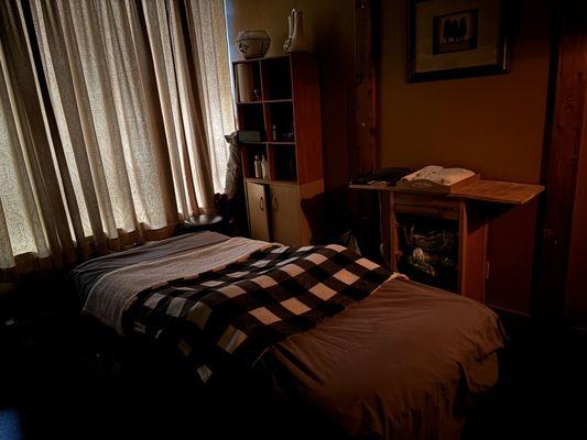 Massage room with heated table pad, room heater, music and the bars on the ceiling so they can walk on your back