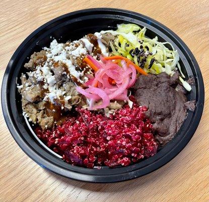 Quinoa bowl with refried black beans and Pork Mixioté