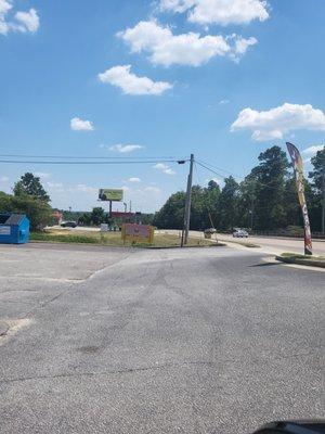 Entrance to the driveway of the restaurant which is located behind the liquor store.