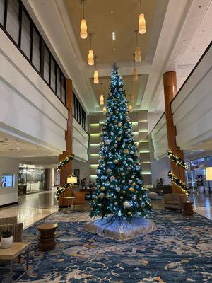 Well decorated Christmas tree located inside front entrance.