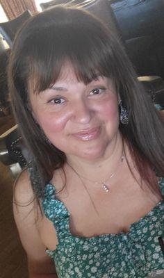 Cyndi, owner, age 58 with a little blush and lipgloss on. She always enjoys her day makeup (coverage) free.