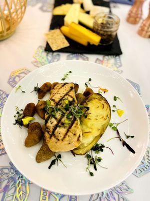 grilled atlantic salmon, tarragon butter within truffle twice baked potato and pumpkin gnocchi, sage butter