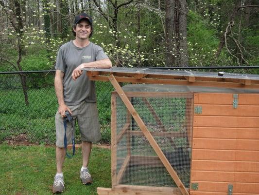 Matt, the owner, and the custom built chicken tractor.