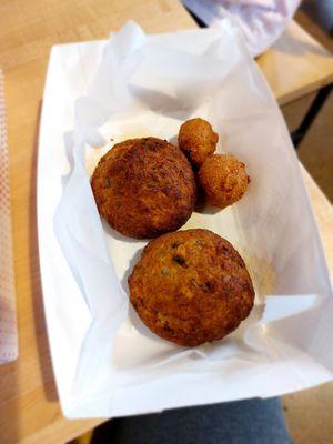 Two crab cakes with hush puppies