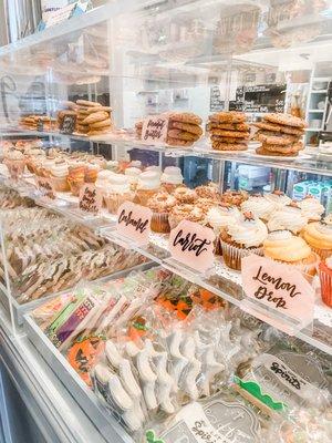 Bakery case filled with cookies and cupcakes