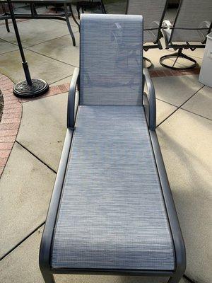 Chaise lounge chair. Fabric was torn. Powder coating was chipped.