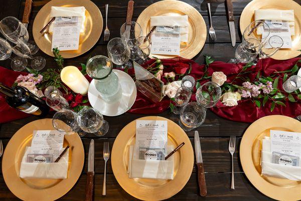 Guest tables with greenery runners and pops of blooms