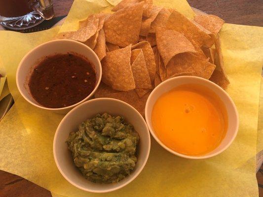 Trio Chips: tortilla chips with three dipping sauces; roasted red pepper, guacamole, and cheese.