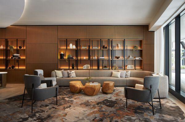 Relax on plush couches in our lobby lounge, surrounded by wood-paneled shelves showcasing local art