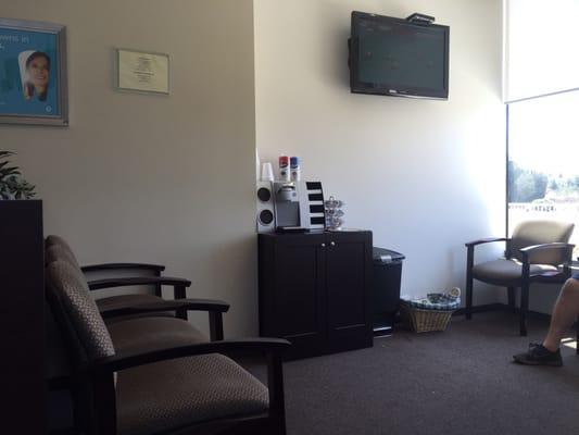 The waiting room with free coffee and a basket with magazines as well as tv with the Olympics while waiting.