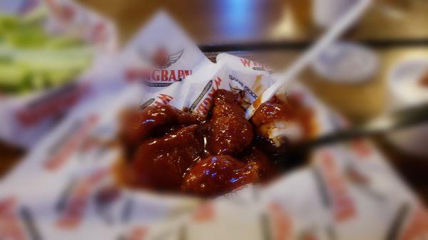 Boneless wings drowning in spicy BBQ sauce.