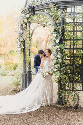 This bride and groom made every moment romantic through their day, even when posing near their wedding arch, they found moments to connect