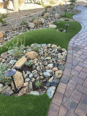 Entrance walkway with artificial turf grass accents.