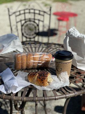 Chocolate hazelnut croissant and a hot cup of coffee with almond milk.