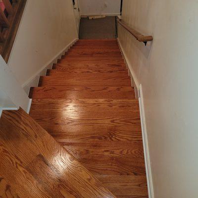 This photo is after removing old pine treads, installing new oak treads, sanding, staining and applying 3 coats of polyurethane.