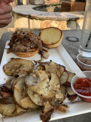 Beef brisket sandwich with home fries.