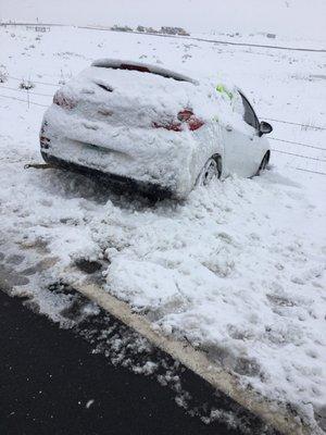 My car in the ditch before Dan rescued it... and yes, that's a foot of snow in the end of May. Thank you Colorado.