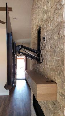 MantelMounts premium motorized mount allows for amazing functionality with over-the-fireplace televisions.