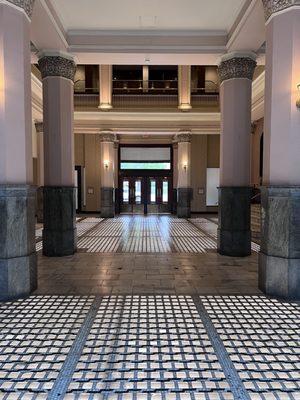 Hall way with pillars to secondary entrance