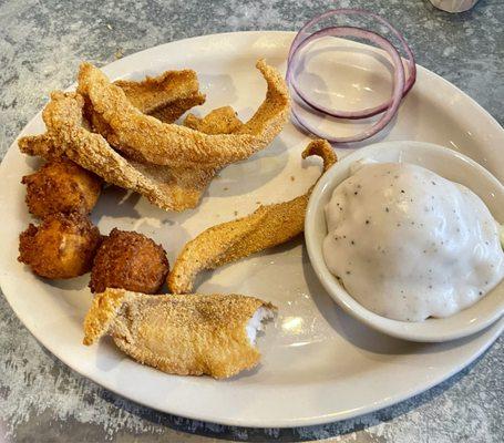 Fried Catfish with hush puppies and mashed potatoes with gravy.